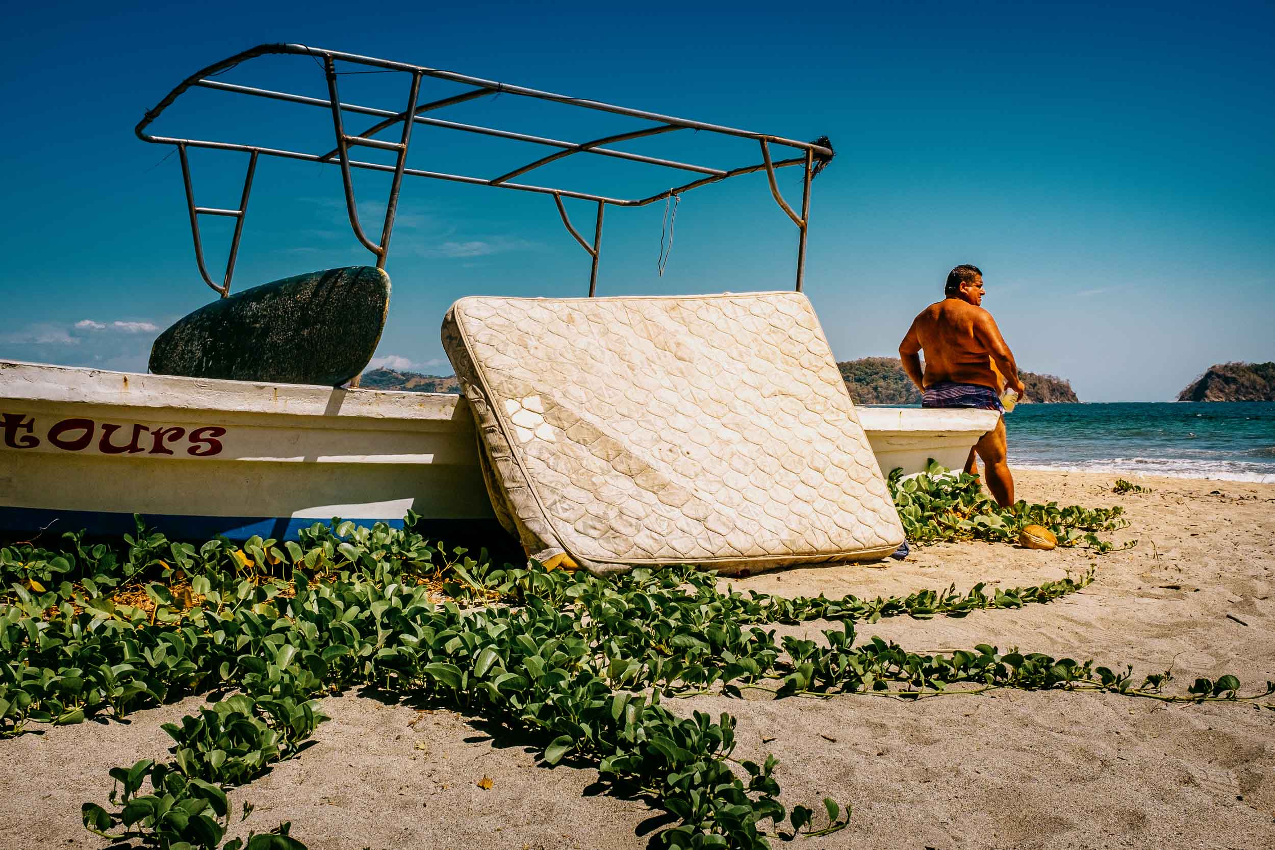 man and boat and mattress samara beach costa rica