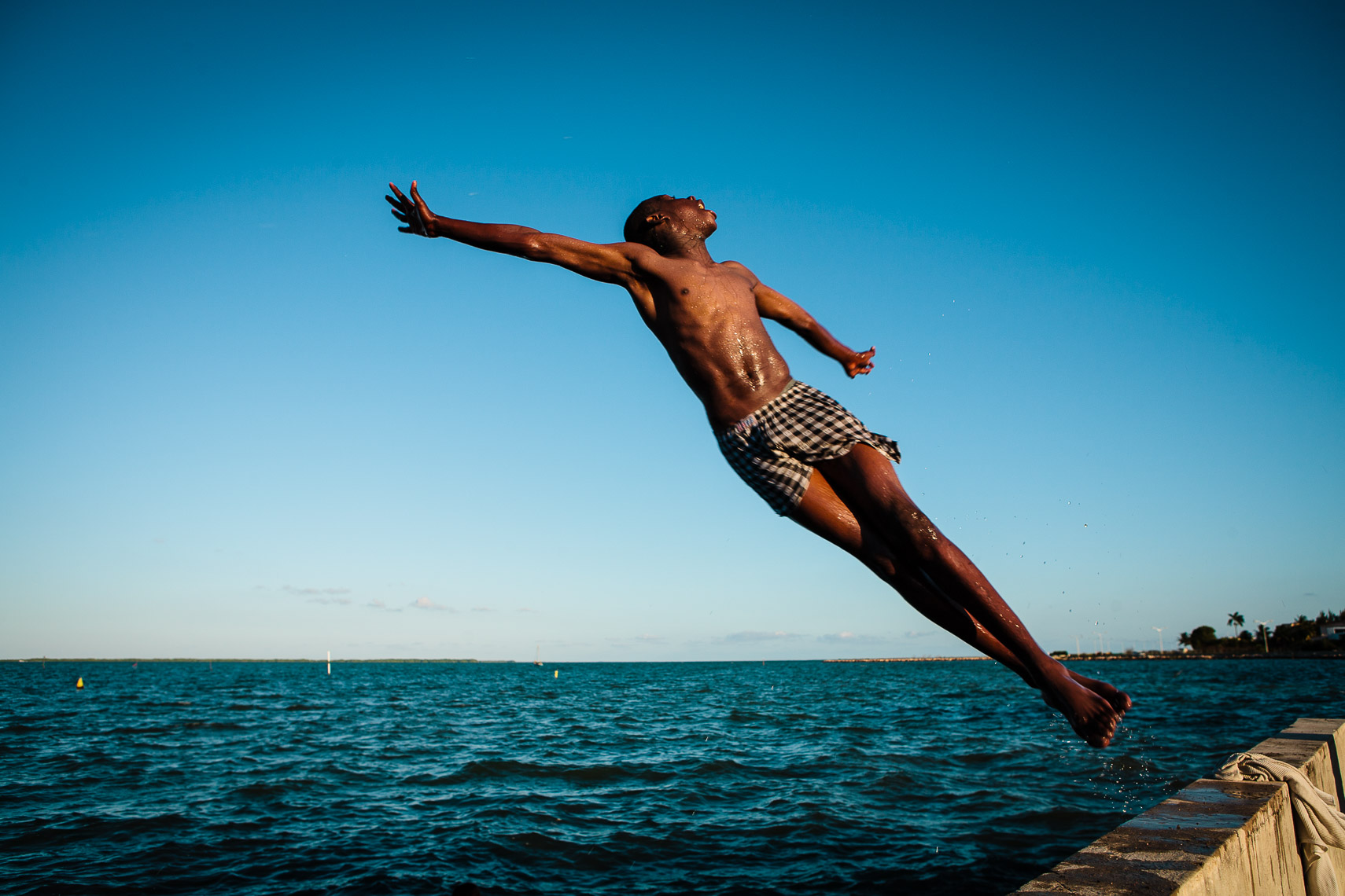 belize city boy jumps off seawall into ocean 