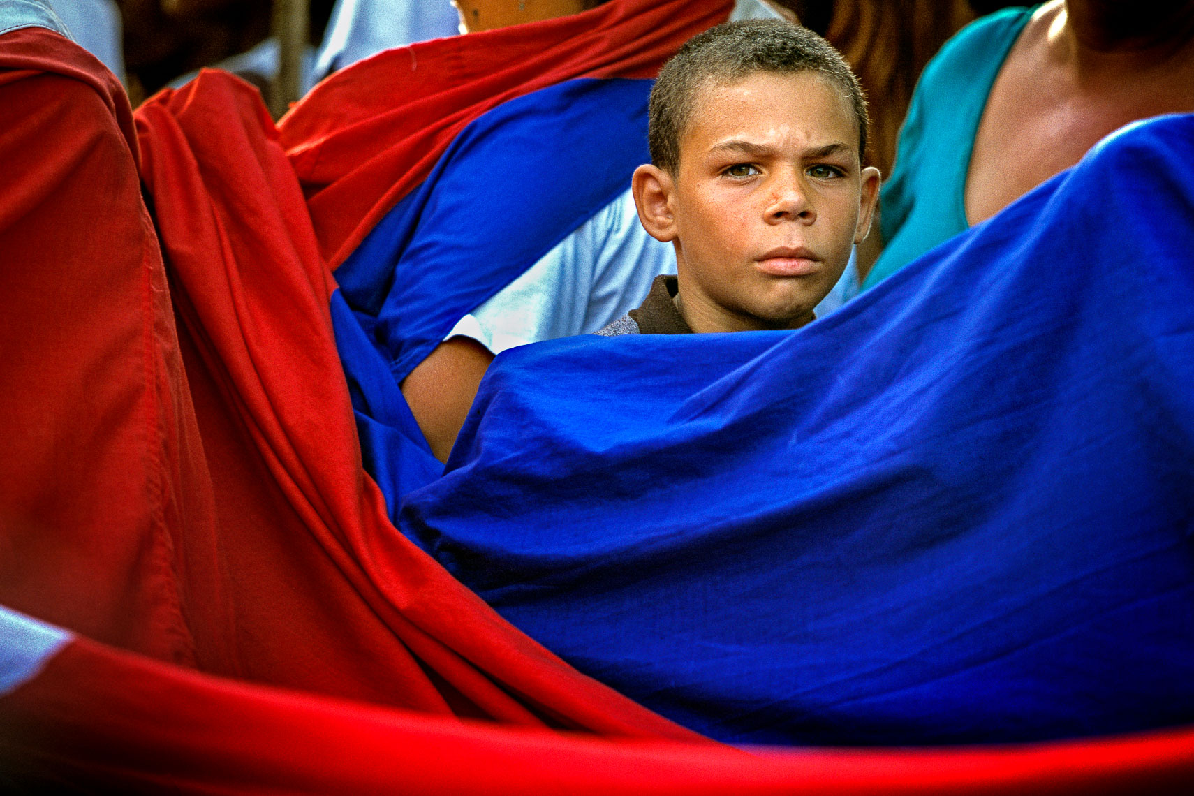 boy holds cuban flag 26 de julio parade malecon havana cuba