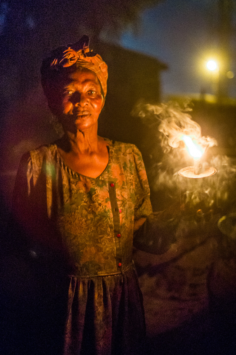 women of teshie ungua drying fish use oil lamps to light the night