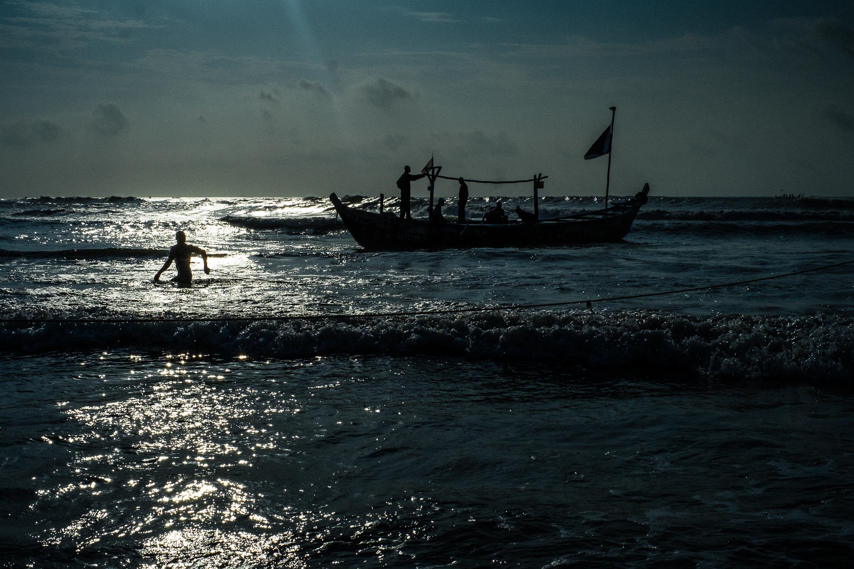 mam hauls in early morning fishing boat - teshie nungua ghana 