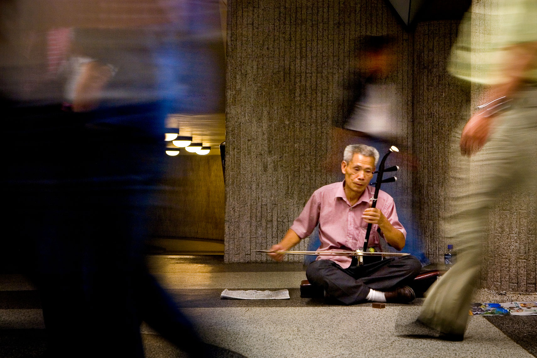 blind musician man in hong kong plays chinese guitar pipa to passersby