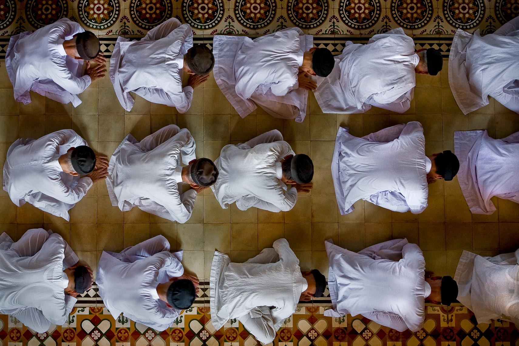 group of caodaiist mons pray at the cao dai temple in tay ninh vietnam