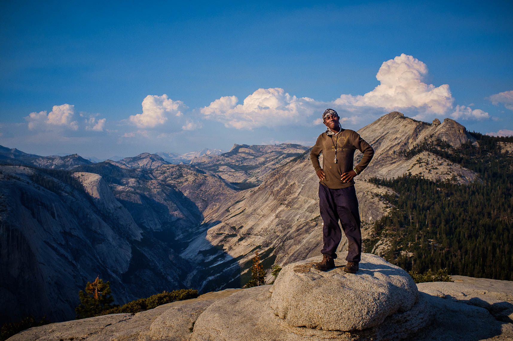 a woods project student stands atop half dome in yosemite national park